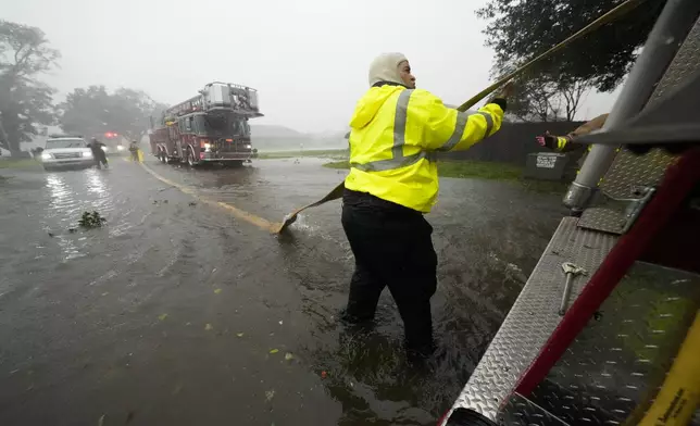 Morgan City firefighters respond to a home fire during Hurricane Francine in Morgan City, La., Wednesday, Sept. 11, 2024. (AP Photo/Gerald Herbert)