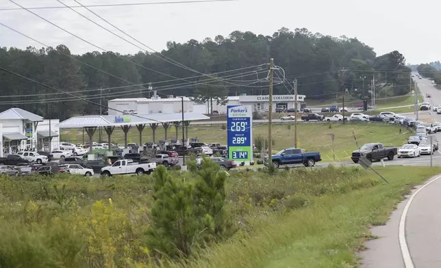 Residents wait in long lines for gas at Parker's Kitchen in the aftermath of Hurricane Helene Sunday, Sept. 29, 2024, in Aiken, S.C. (AP Photo/Artie Walker Jr.)