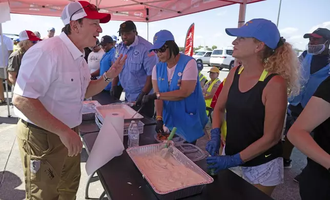 Louisiana Governor Jeff Landry greets volunteers following Hurricane Francine in Houma, La., Friday, Sept. 13, 2024. (Hilary Scheinuk/The Advocate via AP, Pool)