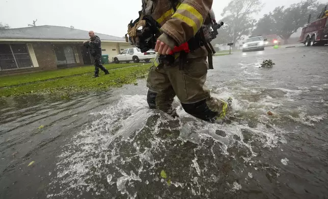 Morgan City firefighters respond to a home fire during Hurricane Francine in Morgan City, La., Wednesday, Sept. 11, 2024. (AP Photo/Gerald Herbert)