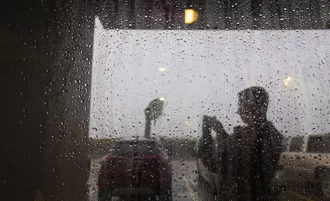 Hotels guests at the Fairfield by Marriott Inn &amp; Suites stand in a protected entryway as they take video of the powerful forces coming from the Hurricane Francine eye wall as it moves across the south on Wednesday, Sept. 11, 2024, in Houma, La. (Photo by Chris Granger, The Times-Picayune)/The Times-Picayune/The New Orleans Advocate via AP)/The Times-Picayune/The New Orleans Advocate via AP)