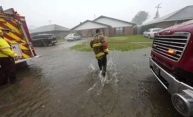 Morgan City firefighters respond to a home fire during Hurricane Francine in Morgan City, La., Wednesday, Sept. 11, 2024. (AP Photo/Gerald Herbert)