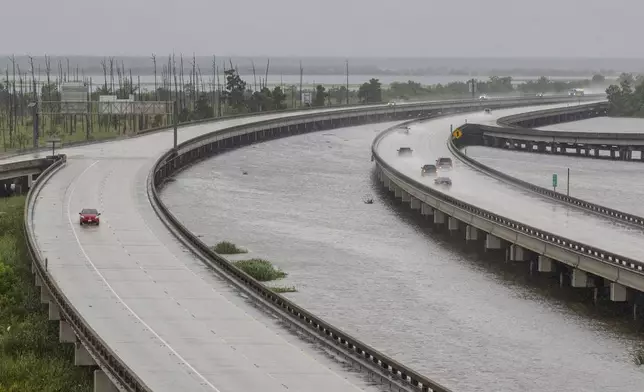 Sparse traffic moves along Interstate 10, Wednesday, Sept. 11, 2024, near Frenier Landing, La., ahead of Hurricane Francine. (David Grunfeld/The Times-Picayune/The New Orleans Advocate via AP)