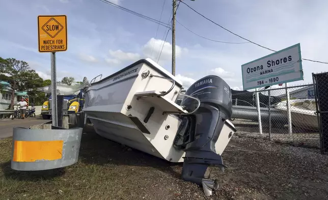 Boats sit on the drive and roadways after being pushed by floodwaters from Hurricane Helene at the Ozona Shores Marina on Friday, Sept. 27, 2024, in Palm Harbor, Fla. (AP Photo/Mike Carlson)