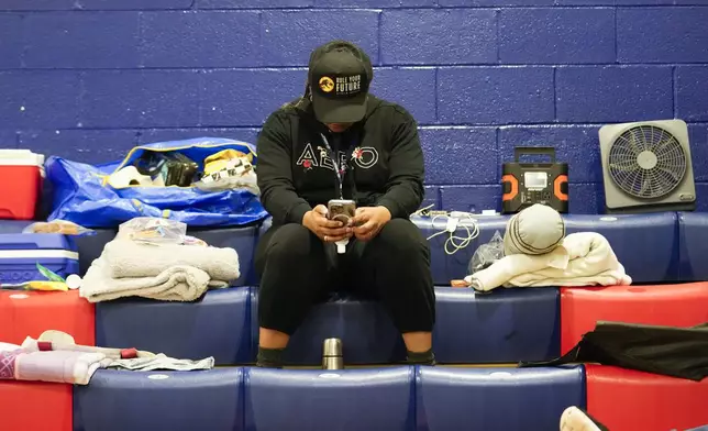 Cindy Waymon, of Tallahassee sits inside a hurricane evacuation shelter at Fairview Middle School, ahead of Hurricane Helene, expected to make landfall here today, in Leon County, Fla., Thursday, Sept. 26, 2024. (AP Photo/Gerald Herbert)