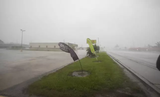 Signage bends in the wind as Hurricane Francine passes through Morgan City, La., Wednesday, Sept. 11, 2024. (AP Photo/Gerald Herbert)