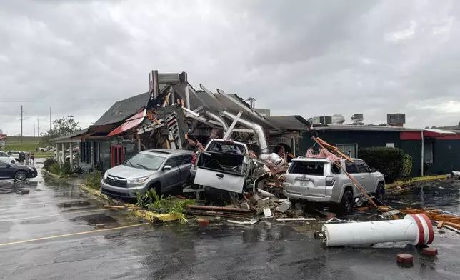 In this photo provided by the City of Rocky Mount, cars are piled along the side of Hing Ta Restaurant after a tornado hit Rocky Mount, N.C., on Friday, Sept. 27, 2024. (City of Rocky Mount via AP)