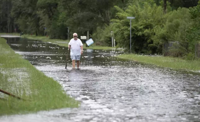 A man walks through floodwaters along Tigris Street in Shoreline Park in Hancock County, Miss., after Hurricane Francine on Thursday, Sept. 12, 2024. (Hannah Ruhoff/The Sun Herald via AP)