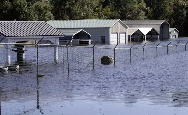 Floodwaters inundated the Trademark Outdoors business on U.S. Highway 17 in Supply, N.C., Tuesday, Sept. 17, 2024. (AP Photo/Chris Seward)