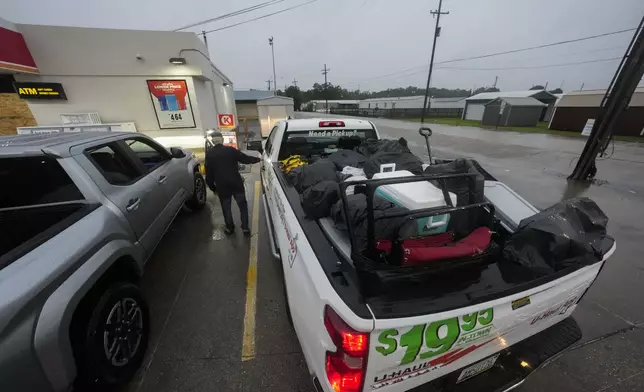 Pat Simon, a resident of Morgan City, stops at a gas station after loading up a rental truck with possessions from his home, as he evacuates to a hotel in anticipation of Hurricane Francine, in Morgan City, La., Wednesday, Sept. 11, 2024. (AP Photo/Gerald Herbert)