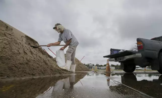 Bubby Longo fills sandbags in the old Kmart/Sears parking lot ahead of Tropical Storm Francine, Monday, Sept. 9, 2024, in Chalmette, La. (David Grunfeld/The Times-Picayune/The New Orleans Advocate via AP)