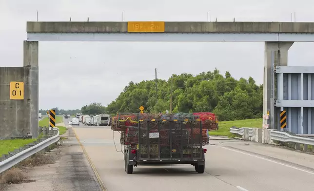 Crabbers move their traps to inside the levy protection system ahead of Tropical Storm Francine, Monday, Sept. 9, 2024, in lower St. Bernard Parish, La. (David Grunfeld/The New Orleans Advocate via AP)