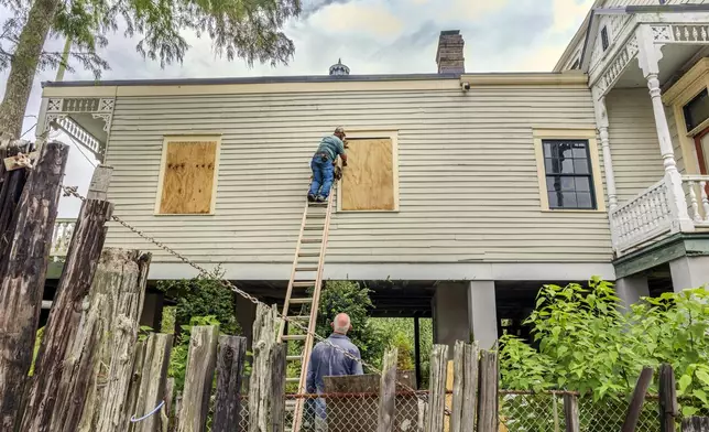 The windows of a raised historic house are boarded up as residents prepare for the arrival of Hurricane Francine along the Louisiana coast on Monday, Sept. 9, 2024, in Lafitte, La. (Chris Granger/The Times-Picayune/The New Orleans Advocate via AP)