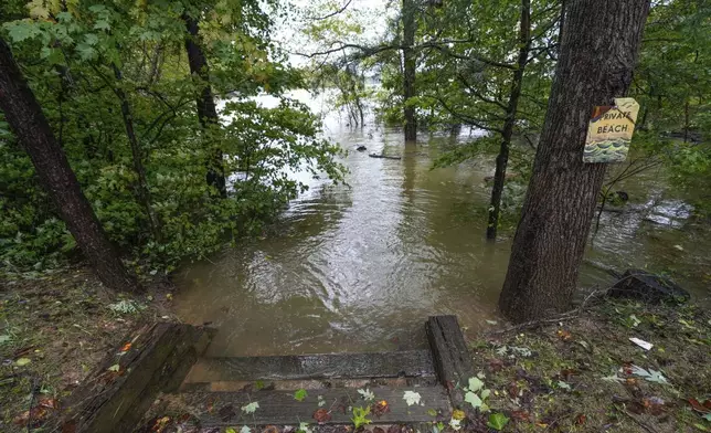 A beach on Lake James is flooded from torrential rain as a result of Hurricane Helene on Friday, Sept. 27, 2024 in Morganton, N.C. (AP Photo/Kathy Kmonicek)