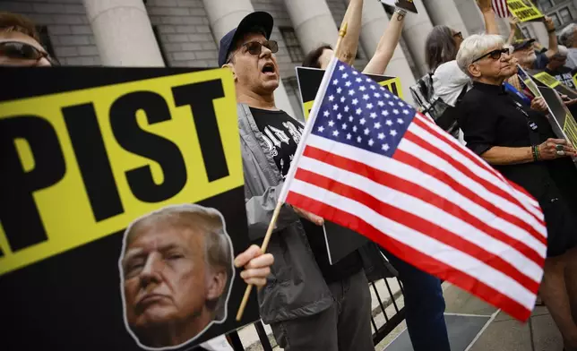 People protest against former President Donald Trump before his arrival to the New York Federal Court, Friday, Sept. 6, 2024, in New York. (AP Photo/Eduardo Munoz Alvarez)