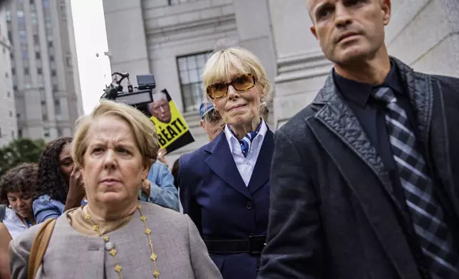 E. Jean Carroll, center, leaves Manhattan federal court with her attorney Roberta Kaplan, left, Friday, Sept. 6, 2024, in New York. (AP Photo/Eduardo Munoz Alvarez)