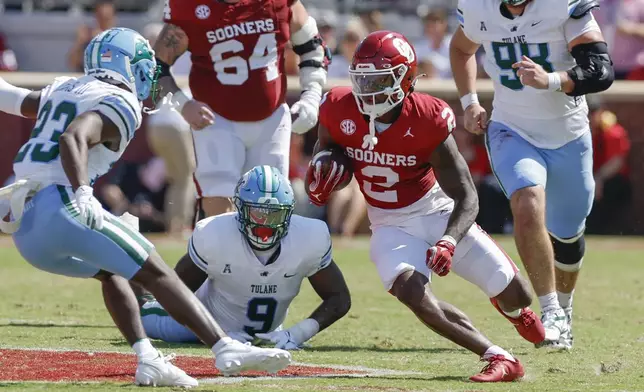 Oklahoma running back Jovantae Barnes (2) runs for a first down against Tulane during the first quarter of an NCAA college football game Saturday, Sept. 14, 2024, in Norman, Okla. (AP Photo/Alonzo Adams)