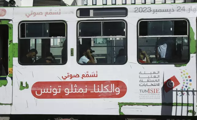 People ride the Metro as it shows banners of the Election Committee, ahead of the upcoming presidential elections, in the capital Tunis, Tunisia, Thursday, Sept. 26, 2024. (AP Photo/Anis Mili)