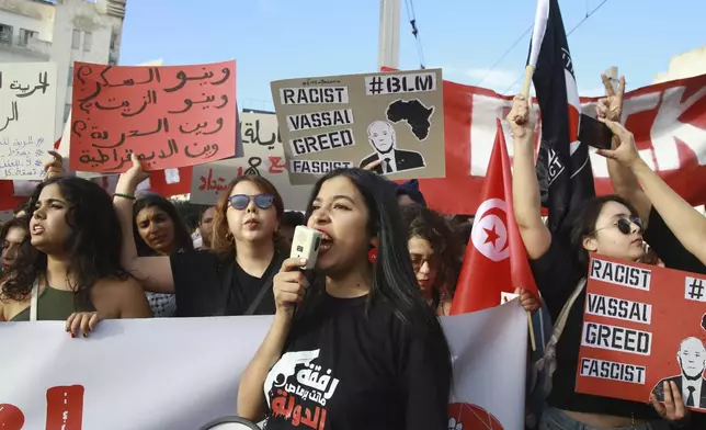 Tunisian take part in a protest against President Kais Saied ahead of the upcoming presidential elections, Friday, Sept. 13, 2024, on Avenue Habib Bourguiba in the capital Tunis. Banner in Arabic reads "Where is sugar? Where is oil? Where is freedom? Where is democracy?" (AP Photo/Anis Mili)