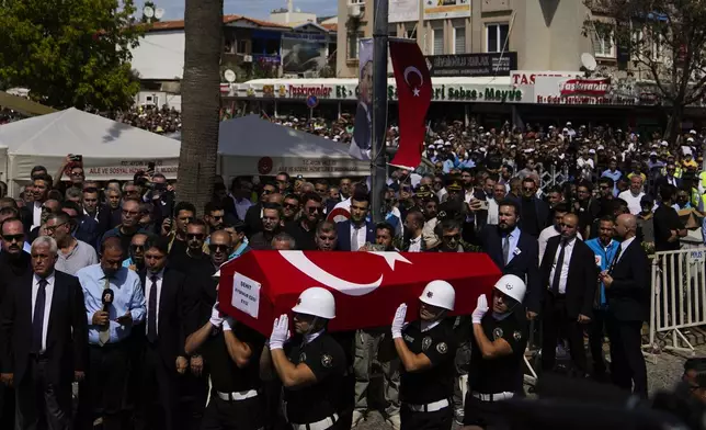 Turkish military police carry the body of Aysenur Ezgi Eygi, 26 year-old Turkish-American activist killed by the Israeli military, for the funeral prayer outside the central mosque of City of Didim, Turkey, Saturday, Sept. 14, 2024. (AP Photo/Khalil Hamra)