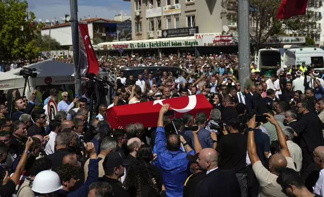 The coffin of Aysenur Ezgi Eygi, a 26 year-old Turkish-American activist killed by the Israeli military, is carried during her funeral in Didim, Turkey, Saturday, Sept. 14, 2024,(AP Photo/Khalil Hamra)