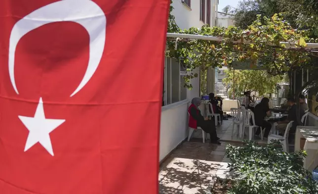 Relatives of Aysenur Ezgi Eygi, the 26 year-old Turkish-American activist killed by the Israeli military, gather outside her family house in the City of Didim, Turkey, Thursday, Sept. 12, 2024. (AP Photo/Khalil Hamra)