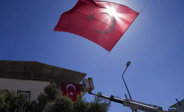 Municipality workers decorate the family house of Aysenur Ezgi Eygi, the 26 year-old Turkish-American activist killed by the Israeli military, with Turkish flags, in City of Didim, Turkey, Thursday, Sept. 12, 2024,(AP Photo/Khalil Hamra)