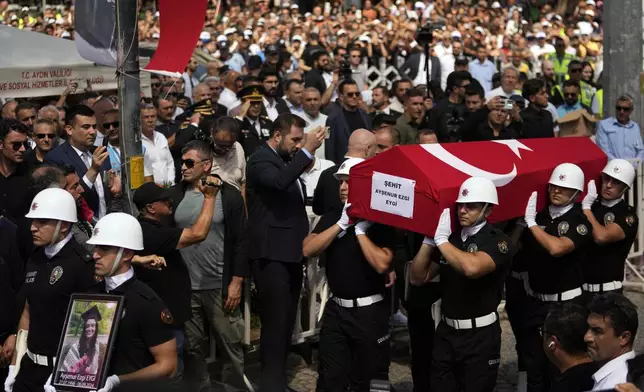 Turkish military police carry the coffin of Aysenur Ezgi Eygi, a 26 year-old Turkish-American activist killed by the Israeli military, for the funeral prayer outside the central mosque of Didim, Turkey, Saturday, Sept. 14, 2024,(AP Photo/Khalil Hamra)