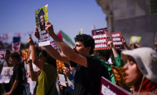 People hold up photographs of Aysenur Ezgi Eygi, 26 year-old Turkish-American activist killed by the Israeli military, as they shout slogans during a protest in her memory in Istanbul, Turkey, Saturday, Sept. 14, 2024. (AP Photo/Francisco Seco)