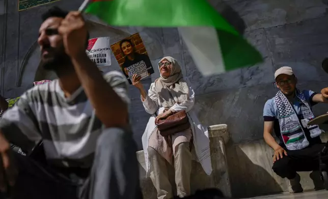 A woman holds up a photograph of Aysenur Ezgi Eygi, 26 year-old Turkish-American activist killed by the Israeli military, during a protest in her memory in Istanbul, Turkey, Saturday, Sept. 14, 2024. (AP Photo/Francisco Seco)