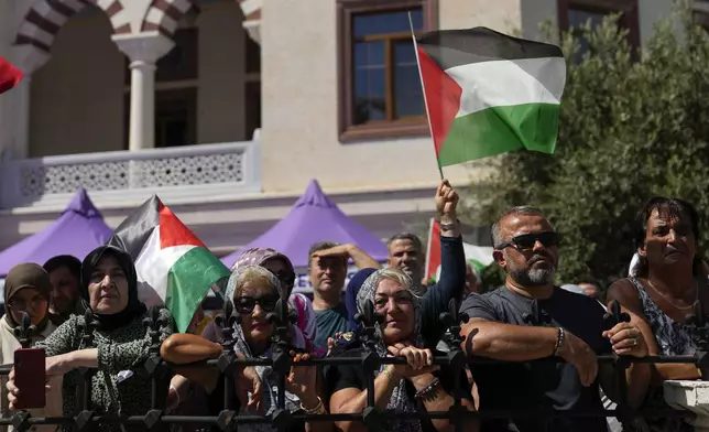 People hold Palestinian flags while attending the funeral of Aysenur Ezgi Eygi, a 26 year-old Turkish-American activist killed by the Israeli military, in Didim, Turkey, Saturday, Sept. 14, 2024,(AP Photo/Khalil Hamra)