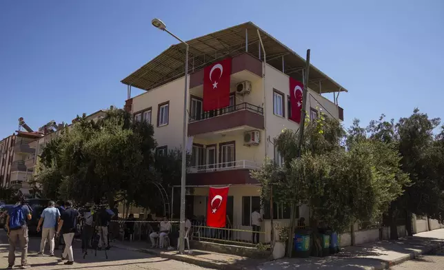 Media members and relatives gather outside the family house of Aysenur Ezgi Eygi, the 26 year-old Turkish-American activist killed by the Israeli military, in the City of Didim, Turkey, Thursday, Sept. 12, 2024. (AP Photo/Khalil Hamra)