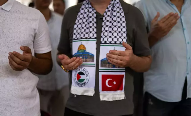 Men attend a funeral prayer in abstentia ceremony in memory of Turkish-American activist Aysenur Ezgi Eygi killed by Israeli gunfire, at Fatih mosque in Istanbul, Turkey, Friday, Sept. 13, 2024. (AP Photo/Francisco Seco)