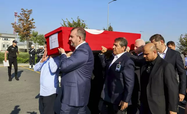 Turkish authorities carry the coffin of Turkish-American activist Aysenur Ezgi Eygi during a ceremony at Istanbul airport, in Istanbul, Turkey, Friday, Sept. 13, 2024. (IHA via AP)