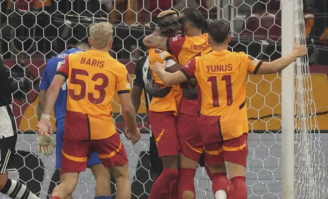 Galatasaray's Victor Osimhen, second left, celebrates with teammates after scoring the opening goal during the Europa League opening phase soccer match between Galatasaray and PAOK at the Ali Sami Yen stadium in Istanbul, Turkey, Wednesday, Sept. 25, 2024. (AP Photo)