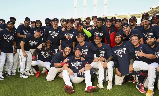 The Cleveland Guardians celebrate after their 10-inning win over the Minnesota Twins in a baseball game, Thursday, Sept. 19, 2024, in Cleveland. (AP Photo/Nick Cammett)