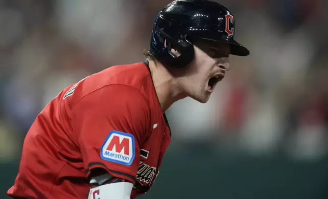 Cleveland Guardians' Kyle Manzardo reacts as he runs the bases after hitting a home run in the eighth inning of a baseball game against the Minnesota Twins, Monday, Sept. 16, 2024, in Cleveland. (AP Photo/Sue Ogrocki)