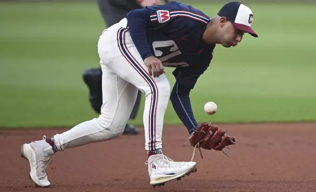 Cleveland Guardians shortstop Brayan Rocchio misplays the ball hit by Minnesota Twins' Carlos Correa during the first inning of a baseball game, Wednesday, Sept. 18, 2024, in Cleveland. (AP Photo/David Dermer)