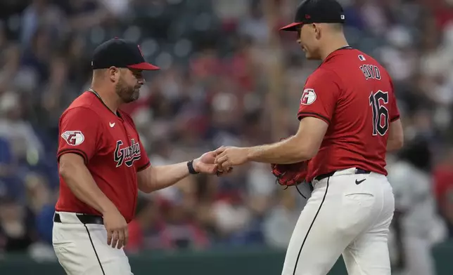 Cleveland Guardians starting pitcher Matthew Boyd (16) is taken out by manager Stephen Vogt, left, in the third inning of a baseball game against the Minnesota Twins, Monday, Sept. 16, 2024, in Cleveland. (AP Photo/Sue Ogrocki)