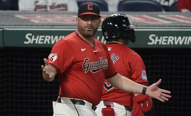 Cleveland Guardians manager Stephen Vogt, left, gestures to home plate umpire Carlos Torres after Bo Naylor, right, was called out on strikes in the fifth inning of a baseball game against the Minnesota Twins, Monday, Sept. 16, 2024, in Cleveland. (AP Photo/Sue Ogrocki)