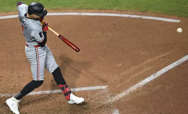 Minnesota Twins shortstop Carlos Correa hits an RBI single during the fifth inning of a baseball game against the Cleveland Guardians, Wednesday, Sept. 18, 2024, in Cleveland. Willi Castro scored on the play.(AP Photo/David Dermer)