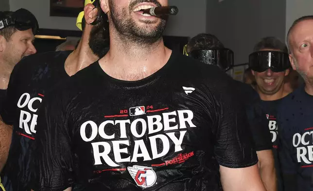 Cleveland Guardians' Austin Hedges celebrates in the clubhouse after they defeated the Minnesota Twins to clinch a baseball playoff berth, Thursday, Sept. 19, 2024, in Cleveland. (AP Photo/Nick Cammett)