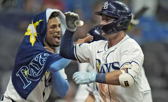 Tampa Bay Rays' Jonny DeLuca, right, celebrates his home run off Minnesota Twins relief pitcher Cole Sands with Christopher Morel during the eighth inning of a baseball game Monday, Sept. 2, 2024, in St. Petersburg, Fla. (AP Photo/Chris O'Meara)