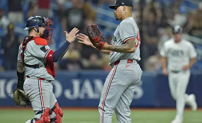 Minnesota Twins relief pitcher Jhoan Duran celebrates with catcher Christian Vazquez after closing out the Tampa Bay Rays during the ninth inning of a baseball game Monday, Sept. 2, 2024, in St. Petersburg, Fla. (AP Photo/Chris O'Meara)