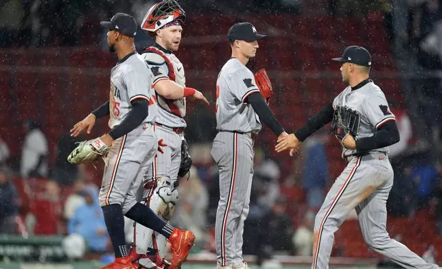 From left to right, Minnesota Twins' Byron Buxton, Ryan Jeffers, Griffin Jax and Trevor Larnach celebrate after defeating the Boston Red Sox in 12 innings of a baseball game, Friday, Sept. 20, 2024, in Boston. (AP Photo/Michael Dwyer)