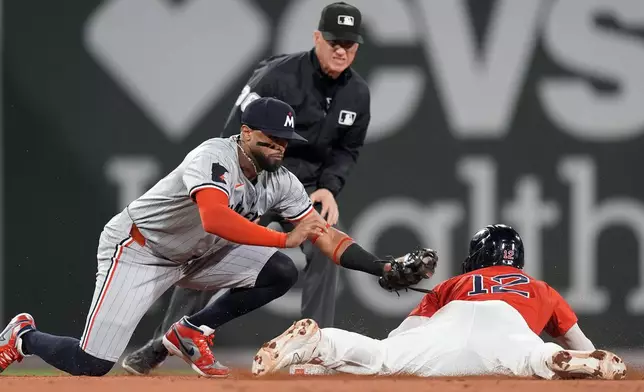 Boston Red Sox's Connor Wong (12) steals second base against Minnesota Twins second baseman Willi Castro, front left, during the sixth inning of a baseball game, Friday, Sept. 20, 2024, in Boston. (AP Photo/Michael Dwyer)