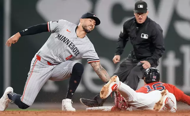 Boston Red Sox's Jarren Duran (16) steals second base against Minnesota Twins shortstop Carlos Correa (4) during the third inning of a baseball game, Friday, Sept. 20, 2024, in Boston. (AP Photo/Michael Dwyer)