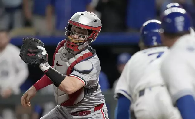 Minnesota Twins catcher Ryan Jeffers, left, tags out Kansas City Royals' Bobby Witt Jr. (7) during the eighth inning of a baseball game, Saturday, Sept. 7, 2024, in Kansas City, Mo. (AP Photo/Orlin Wagner)