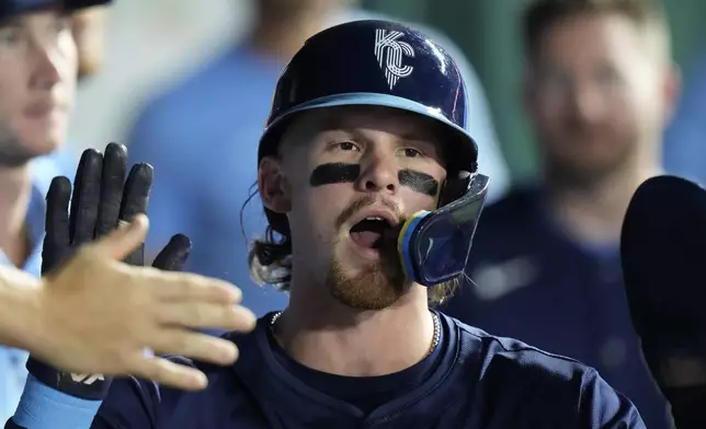 Kansas City Royals' Bobby Witt Jr. celebrates in the dugout after scoring on a two-run single by Hunter Renfroe during the fifth inning of a baseball game against the Minnesota Twins Friday, Sept. 6, 2024, in Kansas City, Mo. (AP Photo/Charlie Riedel)