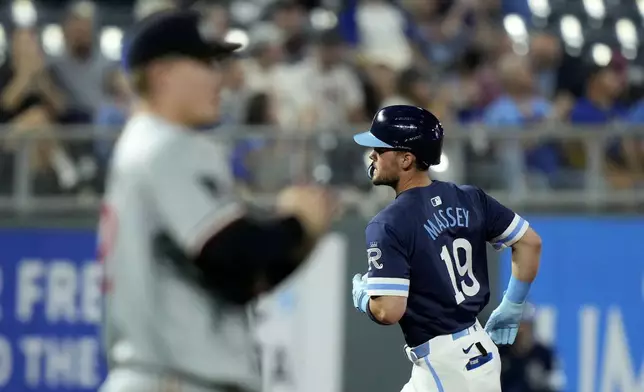 Kansas City Royals' Michael Massey (19) runs the bases past Minnesota Twins starting pitcher Zebby Matthews after hitting a solo home run during the fourth inning of a baseball game Friday, Sept. 6, 2024, in Kansas City, Mo. (AP Photo/Charlie Riedel)